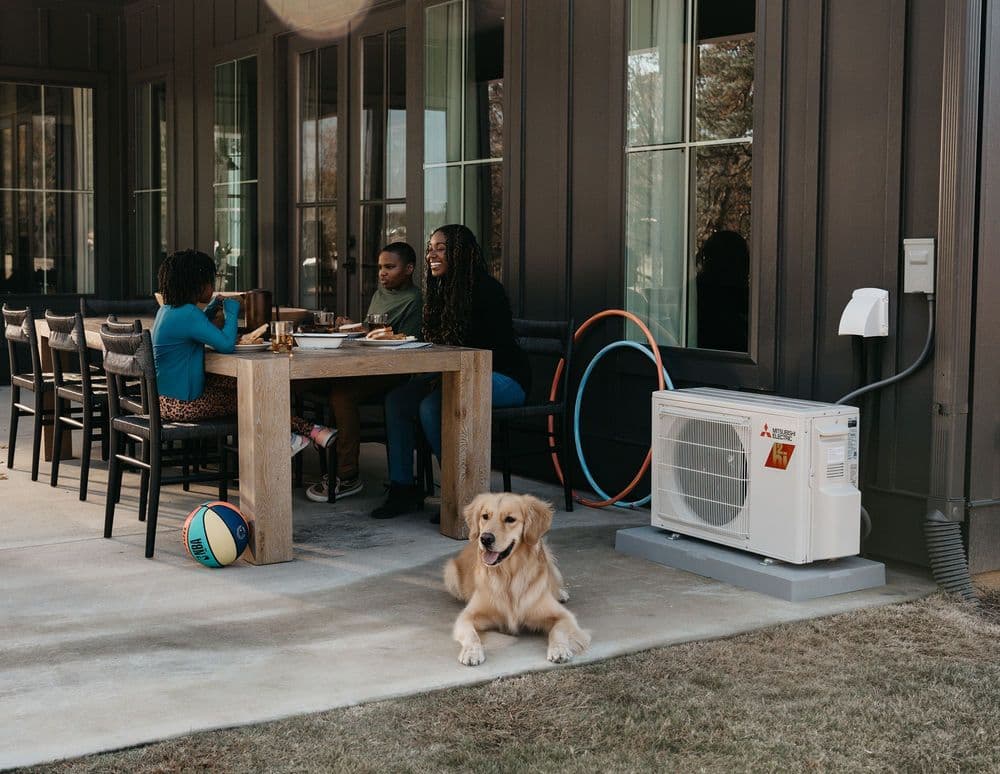 Family eating on patio with outdoor unit 