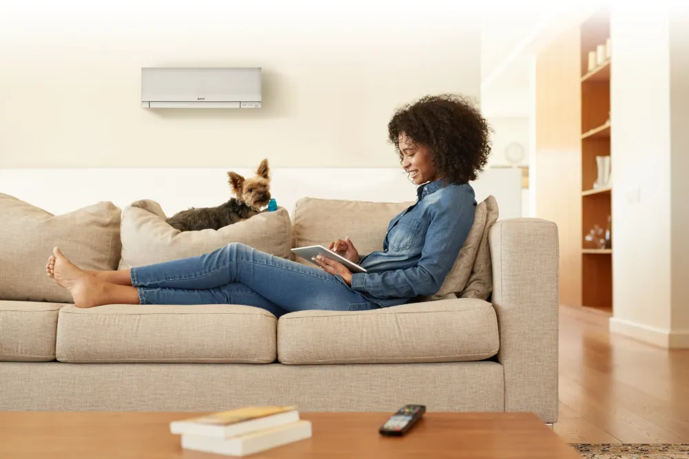 Embrace Shoulder Season with All-Electric Heat Pumpssofa indoors room family sit seat woman house comfort relaxation man apartment contemporary leisure adult looking love people internet