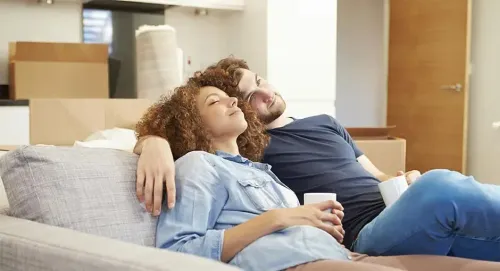 Ductless Mini Split vs. Central Heat & Air indoors woman man reclining relaxation family togetherness sit two leisure room comfort affection adult bed love enjoyment sofa patient